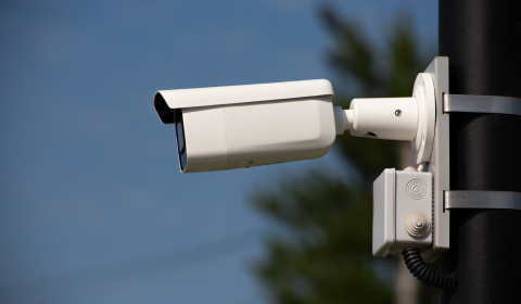 Commercial surveillance camera monitoring a business property
