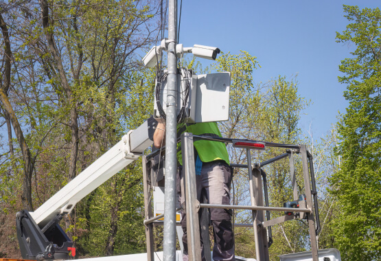 Installer fitting a commercial security system in Plano